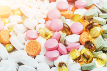 Medical colorful pills, capsules or supplements for the treatment and health care on a light background