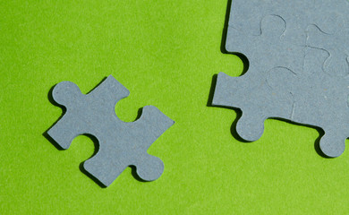 Jigsaw puzzle pieces on bright green background