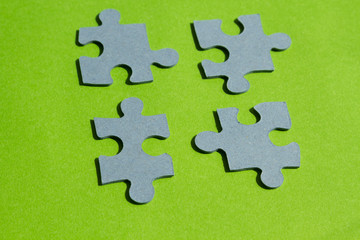 Jigsaw puzzle pieces on bright green background