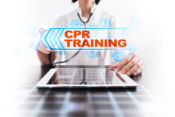 Medical doctor using tablet PC with cpr training medical concept.