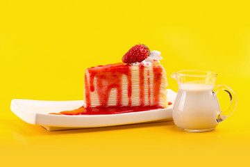 strawberry crepes cake with strawberry sauce on yellow background