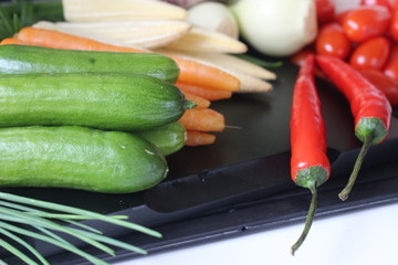 fresh vegetables and herbs, oregano, sage, chive, parsley, dill, onion, cucumber, green vegetables,  red vegetables, tomatoes, peper, red peper,  