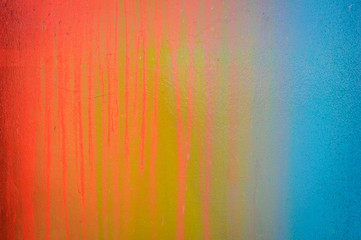 Part of a stone wall with colorful paint marks, paint texture, paint sprayed wall with colorful stains and flowing paint