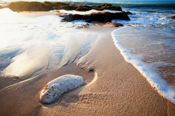 Ocean waves breaking on the rocks on the beach