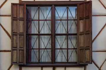 Wooden window of old house made of stone