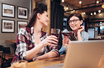Positive delighted brunette holding glass with juice