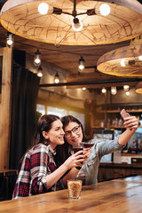 Side view of females while taking selfie