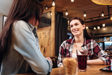 Kind young woman looking attentively at her friend