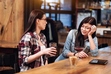 Serious female sitting at bar