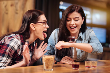 Positive girls playing up in pub