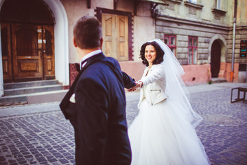 Naklejka premium The charming brides walking along street