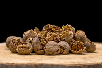 Walnut kernels and whole walnuts wood background