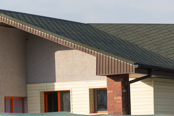 Roof of house with green tiles