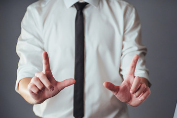 Young businessman showing empty hands, ready to fill with your design