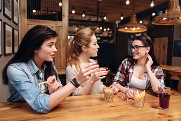 Two girls congratulating their best friend