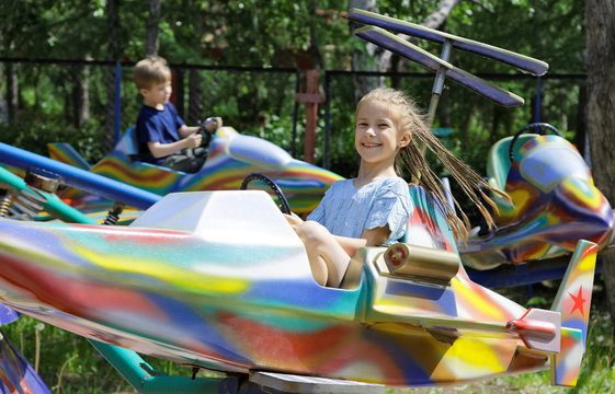 Children, ride on a attraction in park