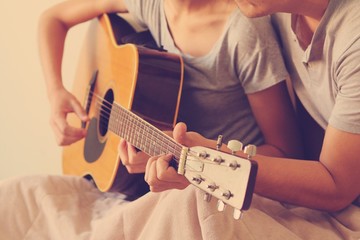 Couple lover playing guitar.