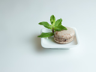 chocolate macaron on a white plate