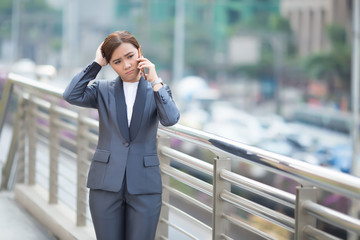 Woman calling the smartphone and she feel sad