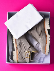 womans grey suede boots with white sole in shopping box