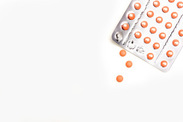 Red pills in blisters isolated on white bachground