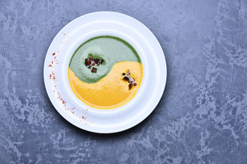 spinach and pumpkin cream soup or puree in infinity sign