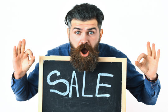 Bearded man, brutal caucasian hipster with moustache holding sale inscription