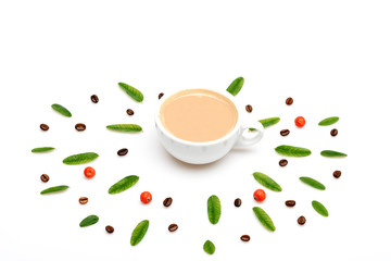 Cup of coffee with milk, coffee leaves, berries and beans