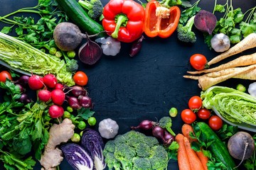 Big set organic food. Fresh raw vegetables. On a black chalkboard.