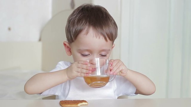 Boy child drinks water from a glass