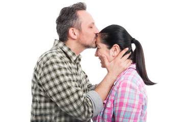 Boyfriend kissing his girlfriend on forehead