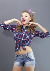 
Sexual  girl in US stile  stand  in front of gray background and look direct
