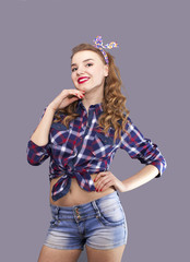
Sexual  girl in US stile  stand  in front of gray background and look direct
