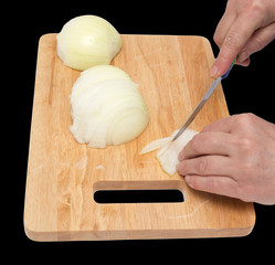 cook onion cut on a board on a black background