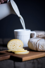 Fresh homemade cheese on wooden board