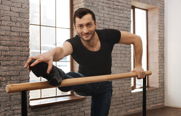 Cheerful ballet dancer performing in the dance studio