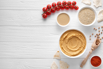 Traditional hummus with ingridients on white table background. Healthy vegetarian nutrition food