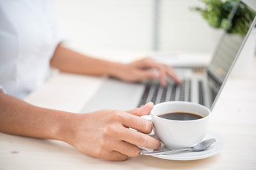 woman hand using keyboard computer on wooden table