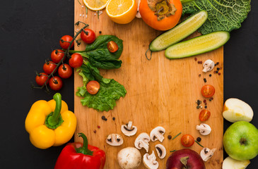Frame of fresh vegetables on wooden background with copy space