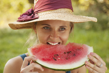 Beautiful happy young woman eating watermelon. Vitamins, nutritional vegetarian food, holiday, diet concept.