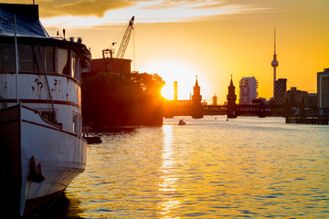 Berlin skyline with old ship wreck in Spree river at sunset, Germany