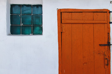 Ancient brown locked doors and a window
