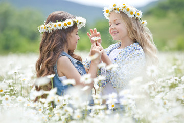 Beautiful little girl on nature with flowers 