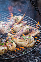 Fresh chicken on grill with rosemary and spices
