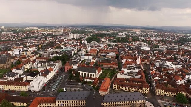 Long aerial shot of the city Fulda. The camera flies slowly over the city of Fulda with all the parks, churches and buildings.