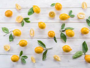 Ripe lemon fruits on the white wooden table.