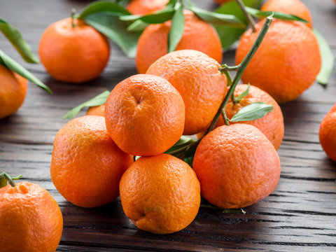 Ripe tangerines on wooden table.