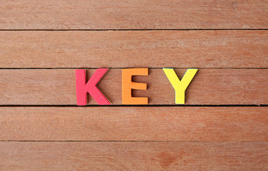 Alphabet letters "KEY" on wood plank. Education concept.