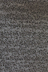 Porous rubber texture of black color. Dark abstract background.
