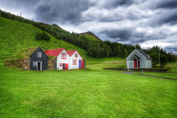 Fototapeta na wymiar Typical small houses in Iceland. Old architecture with grassy roof.